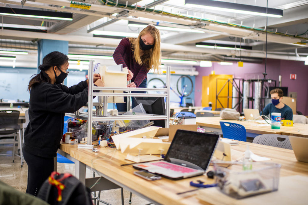 Pei Biorn-Hansen, left, and Kristin Ropiak, both mechanical engineering students, works on their capstone project in the Forsyth building capstone lab on Nov. 24, 2020.